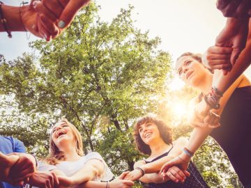 Diverse group of people smiling outdoors in community